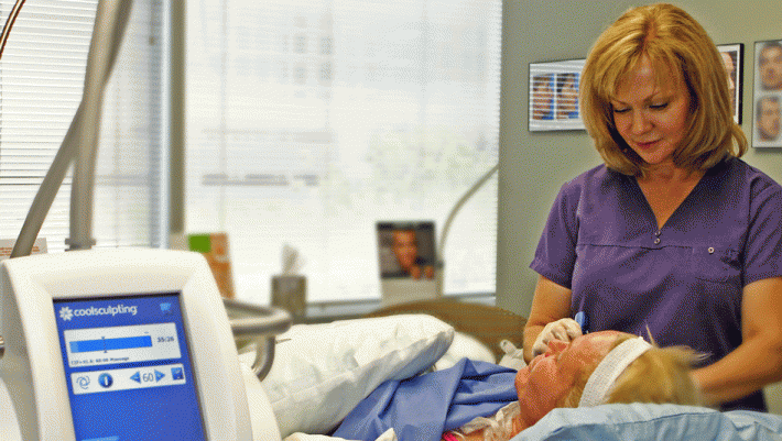 Photo of a facial skin treatment being performed while patient having a CoolSculpting treatment to the body