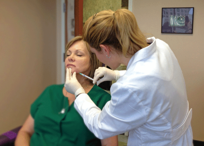 Corinn injecting woman&#039;s chin