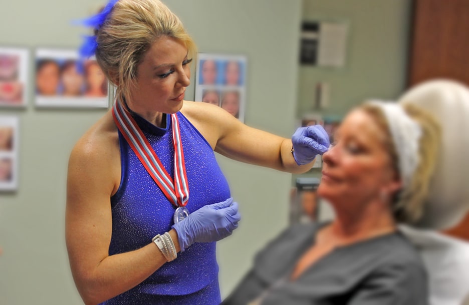 Corinn Singletary PA-C demonstrating dermal filler and liquid facelift during Halloween party