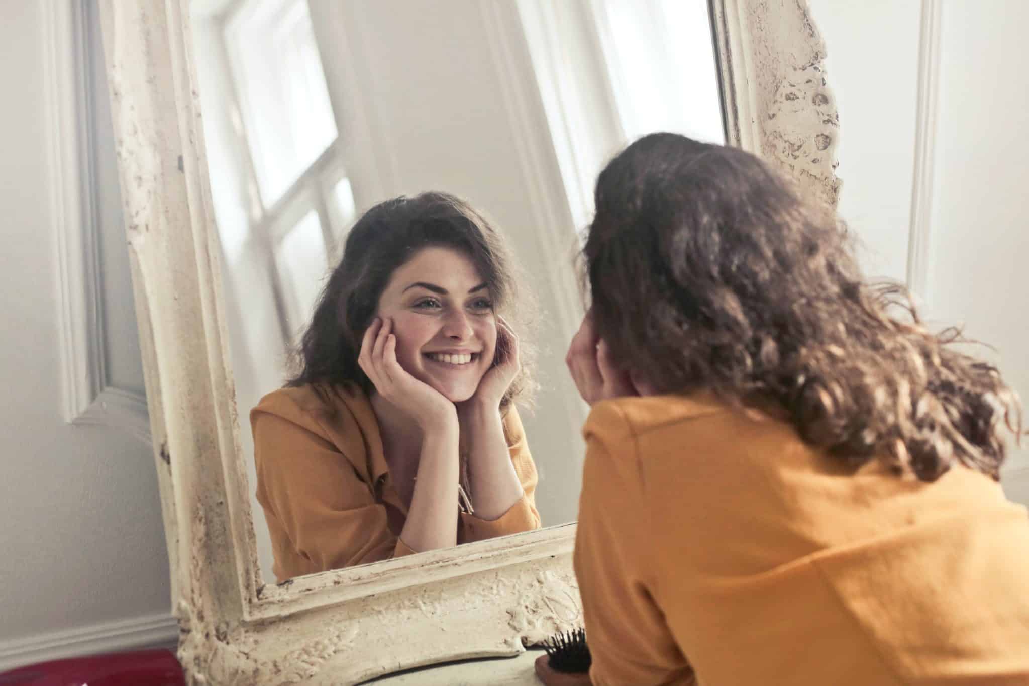 attractive woman admiring face in mirror after IPL